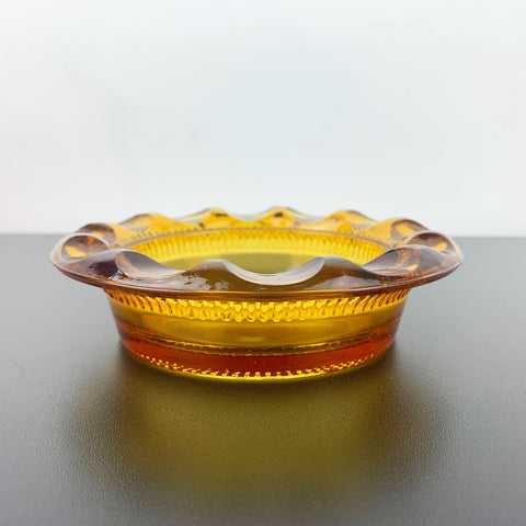 Amber glass ashtray with thumbprint rim design