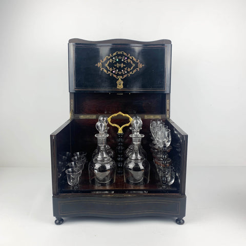 Antique French ebonized wood liquor cabinet with inlaid brass and mother of pearl detail
