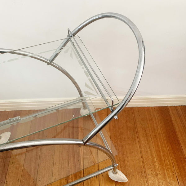 Australian art deco chrome and glass bar cart with bakelite wheel skirts