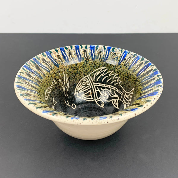 Tribal style decorative fish bowl with carved fish