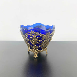 Corbell & Co ornate cherub footed bowl with cobalt blue glass insert
