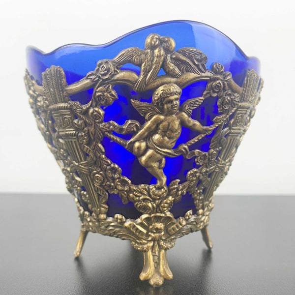 Corbell & Co ornate cherub footed bowl with cobalt blue glass insert