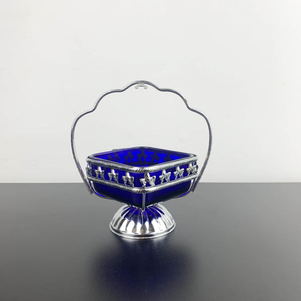 Ornate metal footed condiment bowl with cobalt blue glass insert