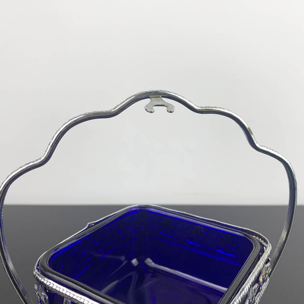 Ornate metal footed condiment bowl with cobalt blue glass insert