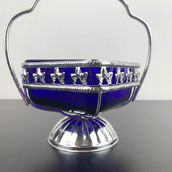 Ornate metal footed condiment bowl with cobalt blue glass insert