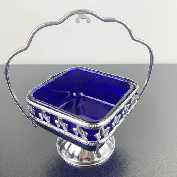 Ornate metal footed condiment bowl with cobalt blue glass insert