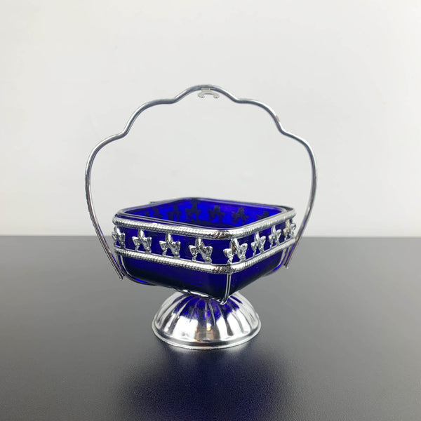 Ornate metal footed condiment bowl with cobalt blue glass insert