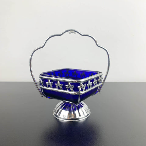 Ornate metal footed condiment bowl with cobalt blue glass insert