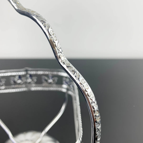 Ornate metal footed condiment bowl with cobalt blue glass insert