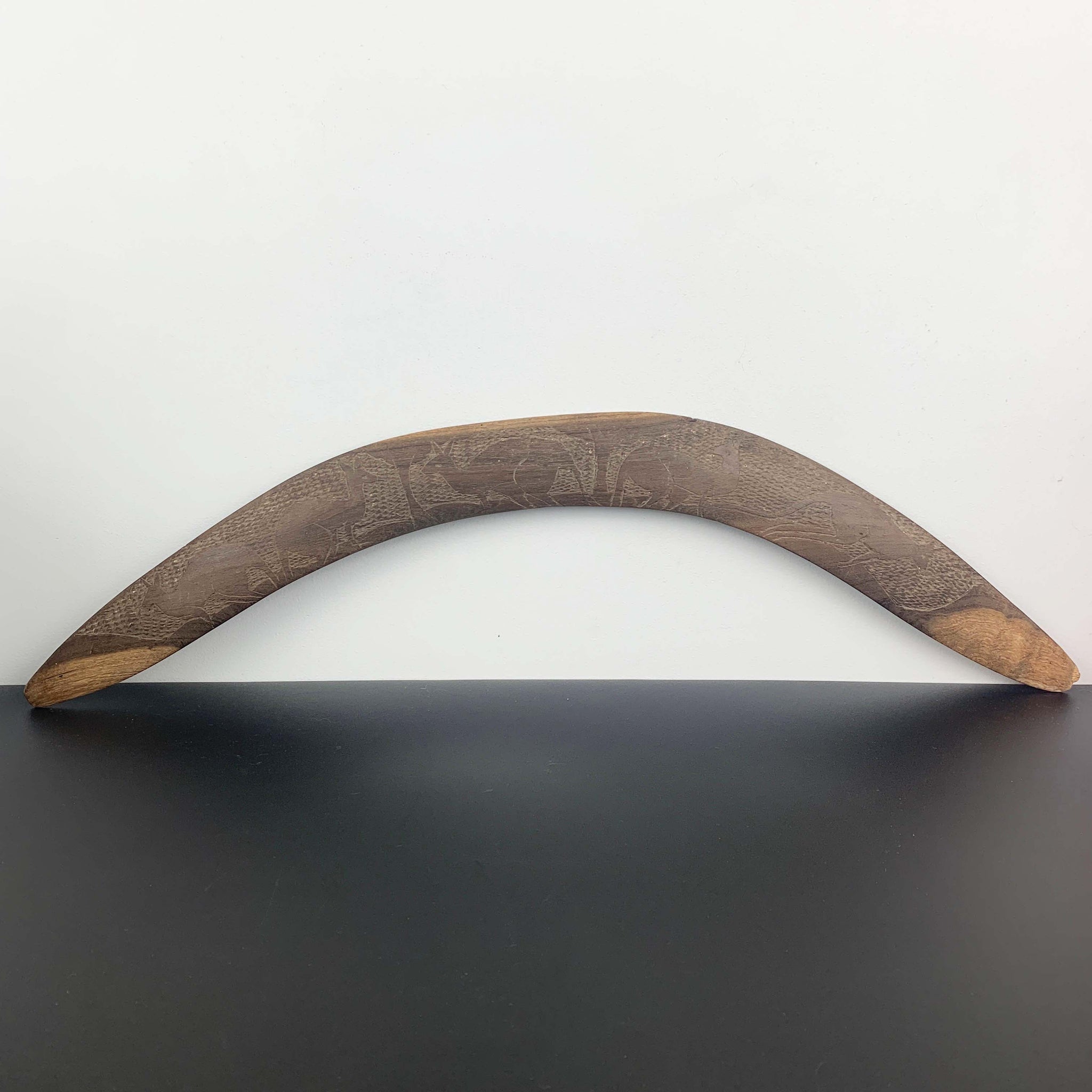 Aboriginal hand made boomerang with intricate carved kangaroo art