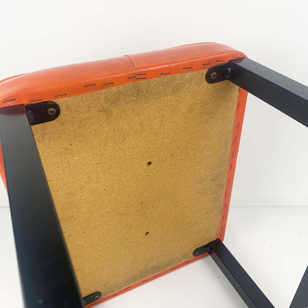 Upholstered mid century orange vinyl stool with black metal legs