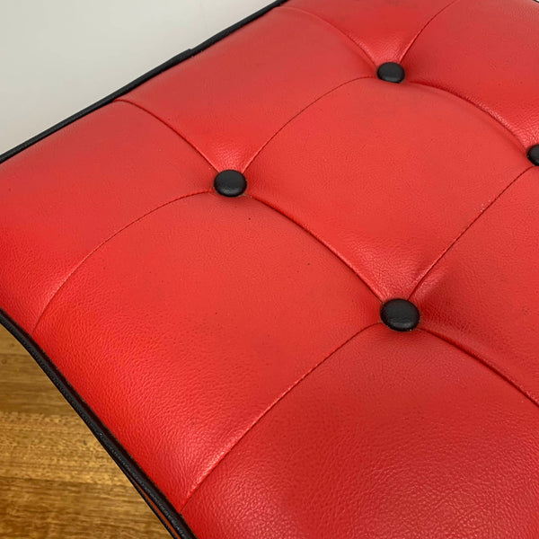 Mid century red vinyl stool with black button tufting
