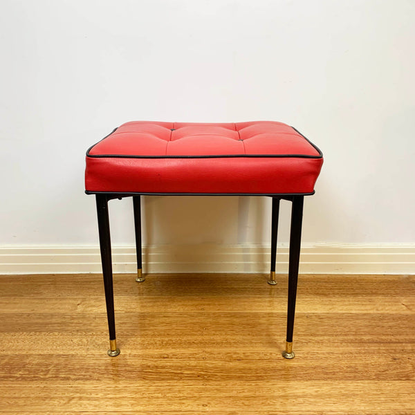 Mid century red vinyl stool with black button tufting