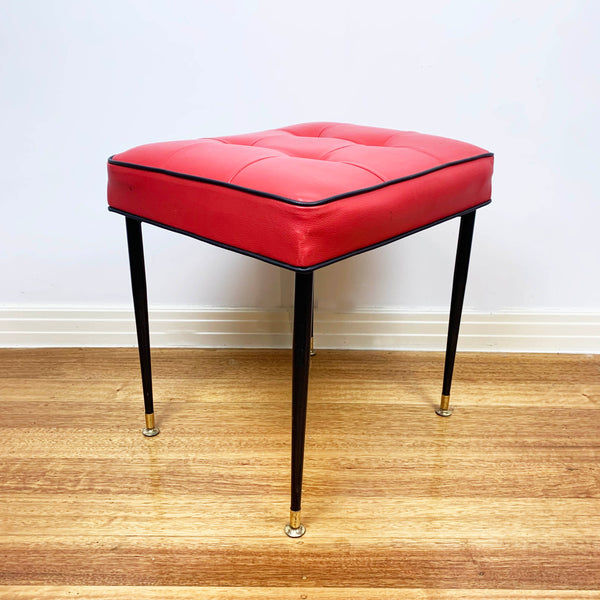 Mid century red vinyl stool with black button tufting