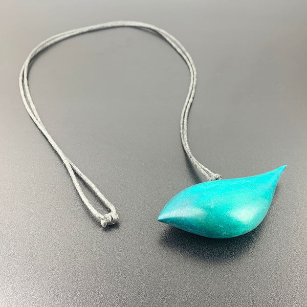 Hand crafted wooden bird necklace in teal