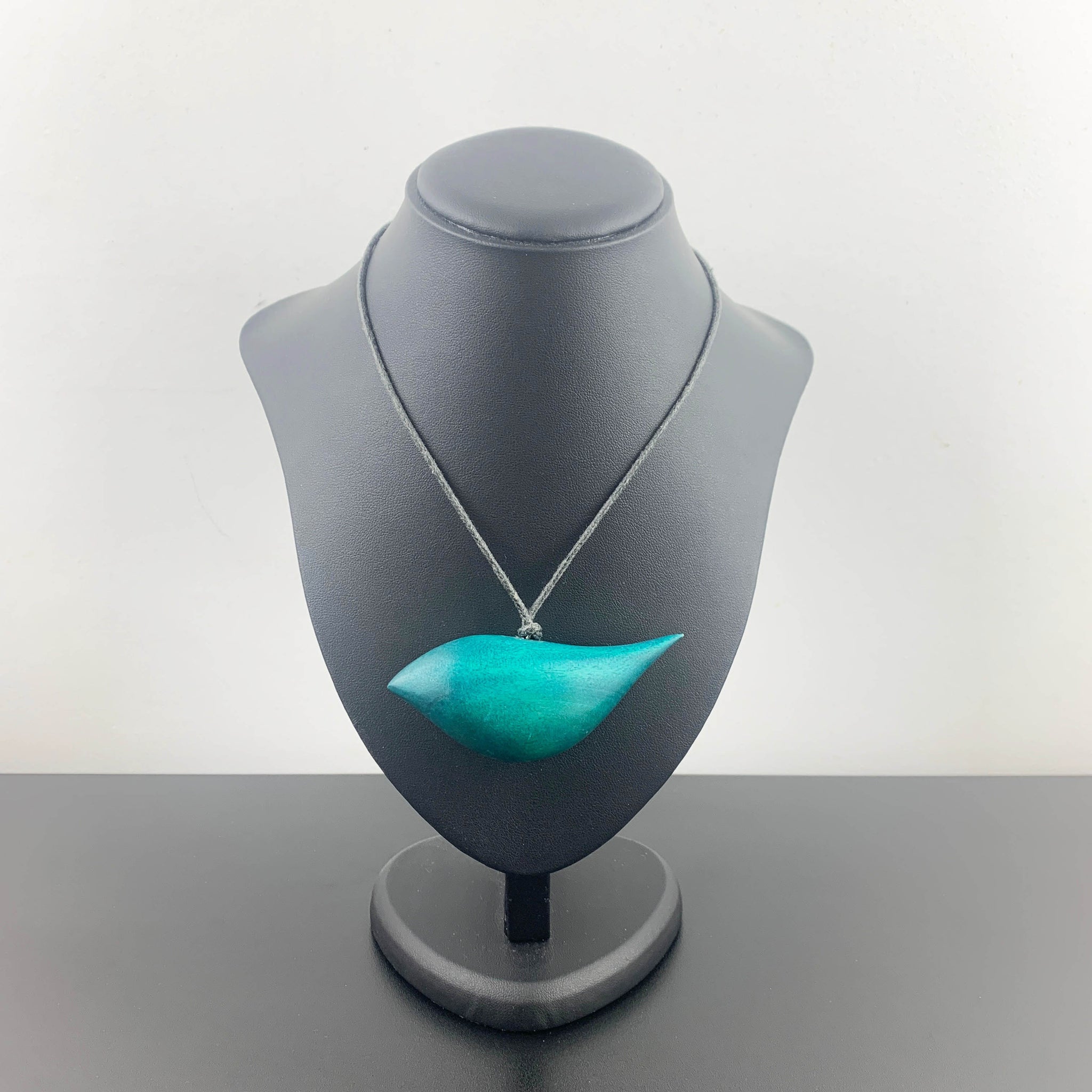 Hand crafted wooden bird necklace in teal
